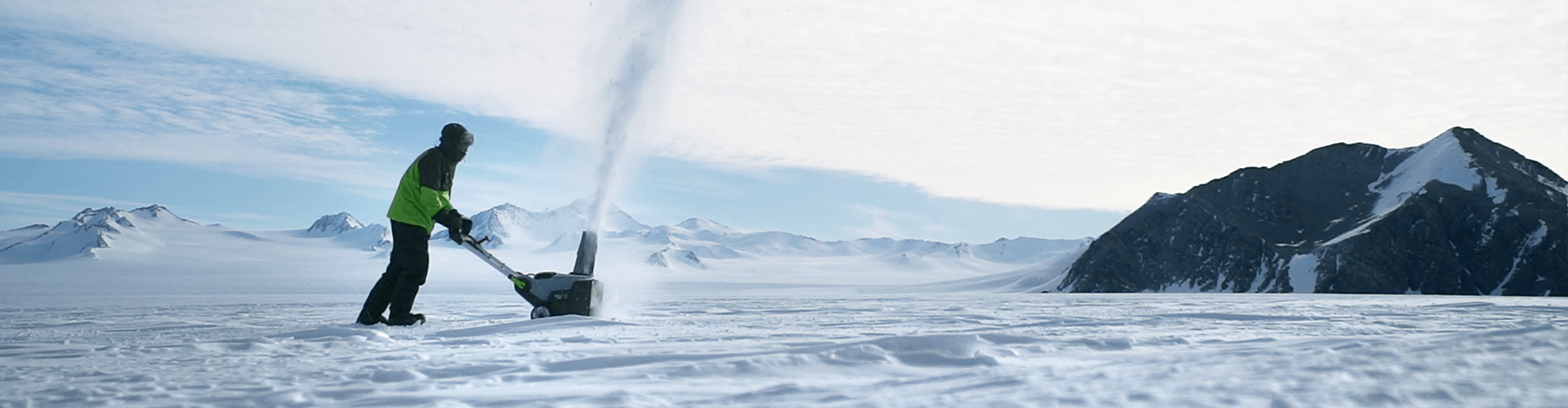 A man testing an EGO Snow Blower in a vast snowy environment.