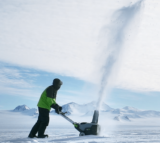 A man testing an EGO Snow Blower in a vast snowy environment.